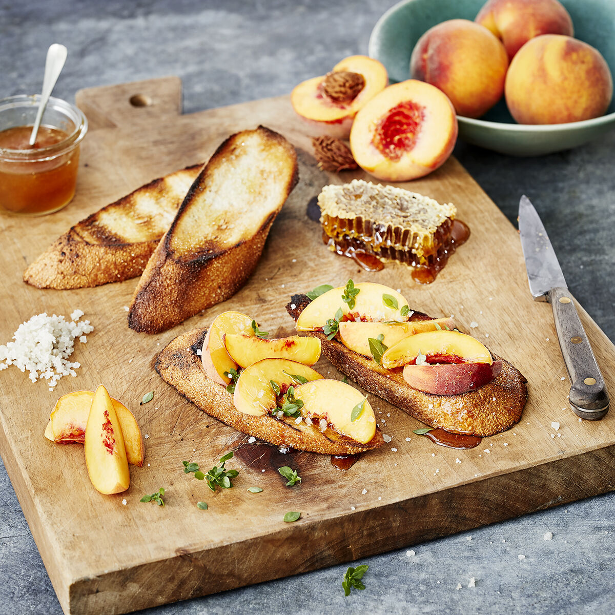 Peach Toast with Garden Honey & Spicy Bush Basil on a cutting board